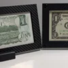 Straight-on view of two budget currency frames with sample notes