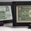 Overlapping view of two 4-mil currency frames showing their black carbon-fiber borders