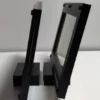 Side profile of two budget currency frames on their display stands
