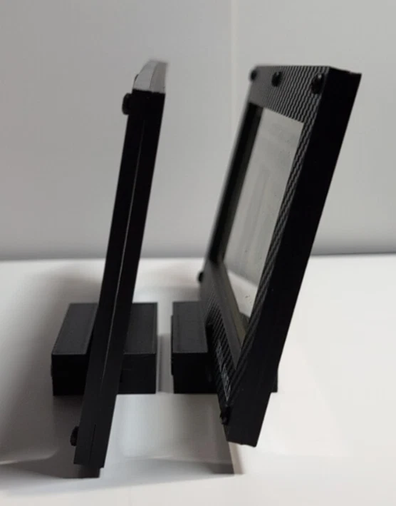 Side profile of two budget currency frames on their display stands