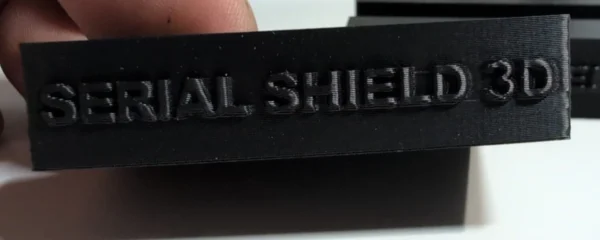 Close-up of the Serial Shield 3D™ branding on a budget currency-frame stand
