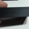 Close-up of the rear support foot on a budget currency-frame stand