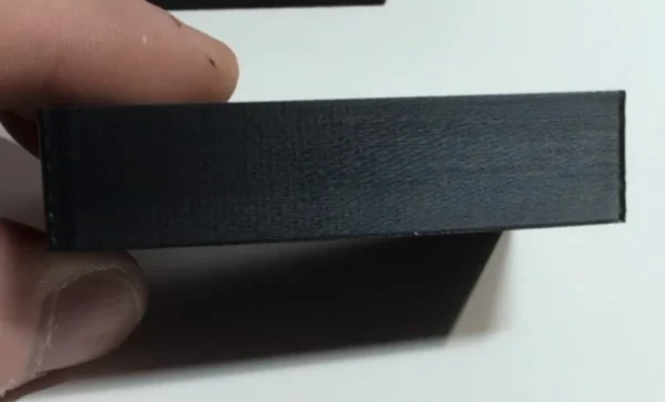 Close-up of the rear support foot on a budget currency-frame stand