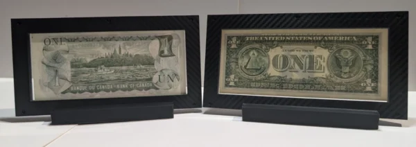 Angled front view of two premium currency frames positioned side by side