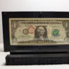 Straight-on front view of a premium currency frame with a sample U.S. one-dollar note