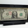 Angled front view of a premium currency frame and its black display stand