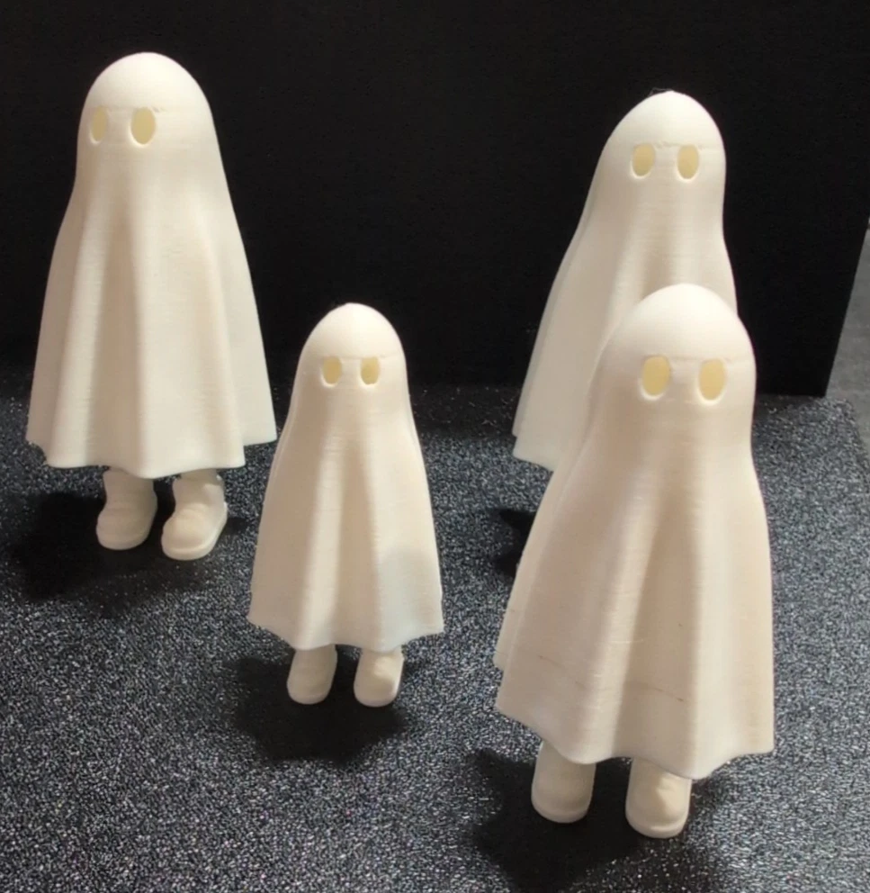Group of four white ghost shelf sitters in different sizes with their legs extended