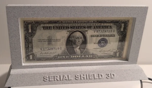 Platinum 10-Mil Currency Display Frame with Stand – Front Close Display | Serial Shield 3D™ Close front view of the framed one-dollar note and branded base