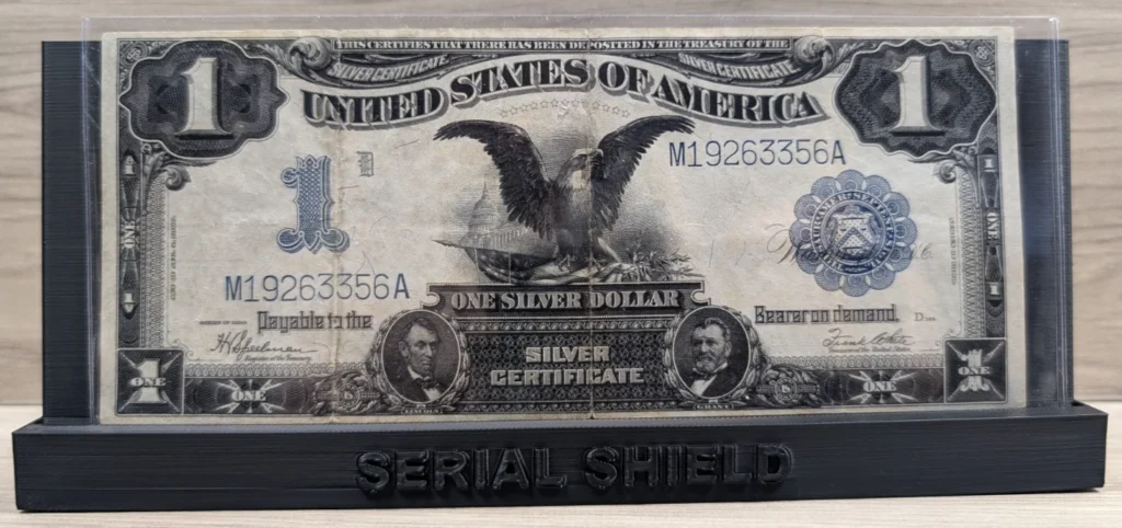 Front view of an 1899 Black Eagle graded banknote slab on the display stand